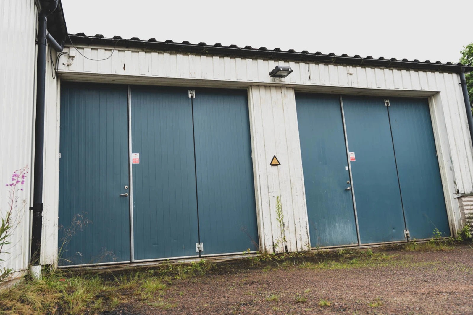 Two 41-year-old bi-folding doors at a car workshop