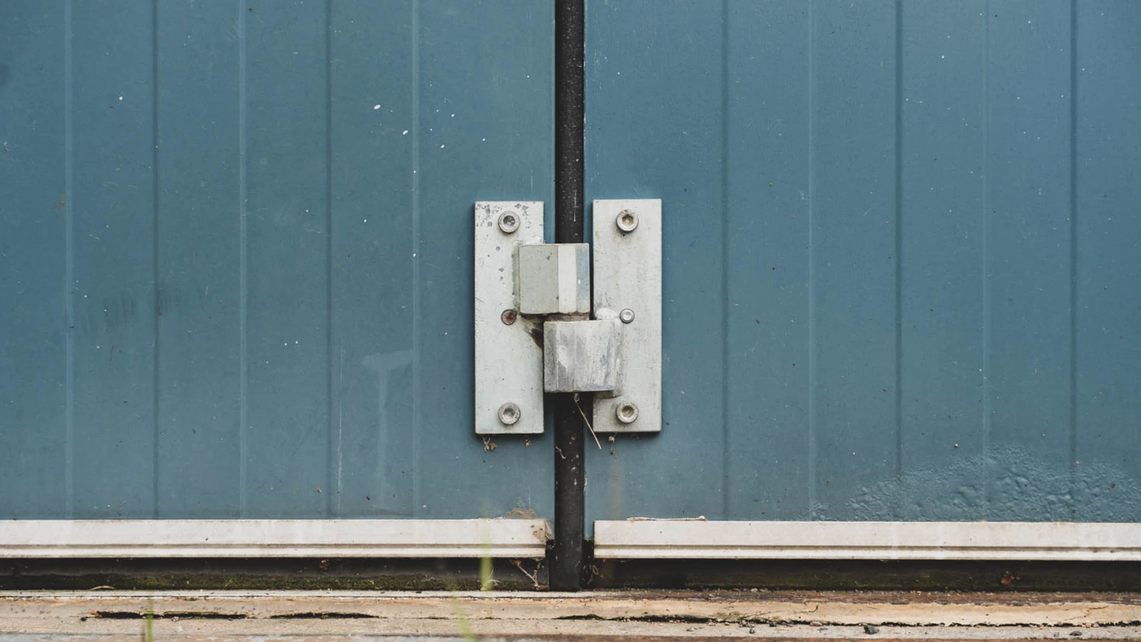 Close-up of a 41-year-old Torverk bi-folding door with minor rust along the bottom edge