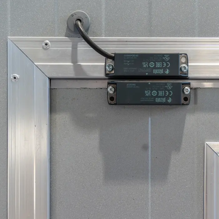 Alarm sensor for monitoring the pedestrian door’s status
